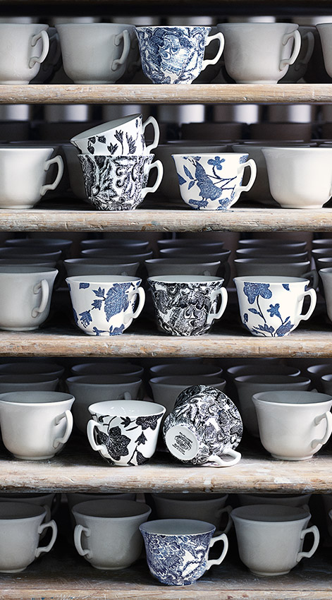Shelves filled with floral-patterned mugs & plates with star motifs