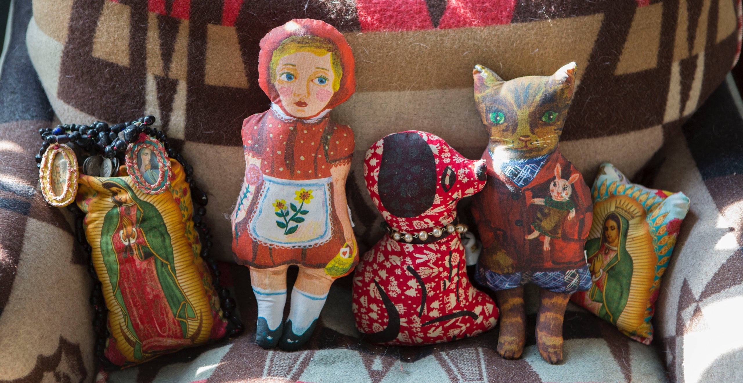 Caperucita Roja y sus amigos c&oacute;modamente instalados en el div&aacute;n de una habitaci&oacute;n y tapados con una vieja manta de Ralph Lauren 