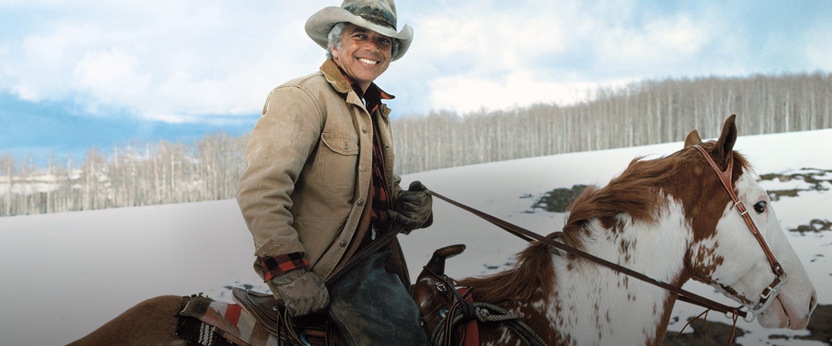 Mr. Lauren riding on horseback on snow-covered mountain
